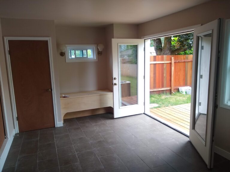 Garage conversion interior with french doors and tile floor